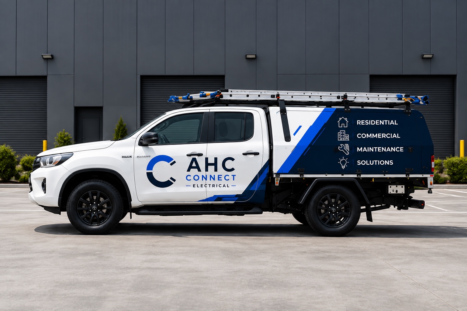 The AHC Connect ute: white dual-cab with a navy canopy, blue graphics and branded doors